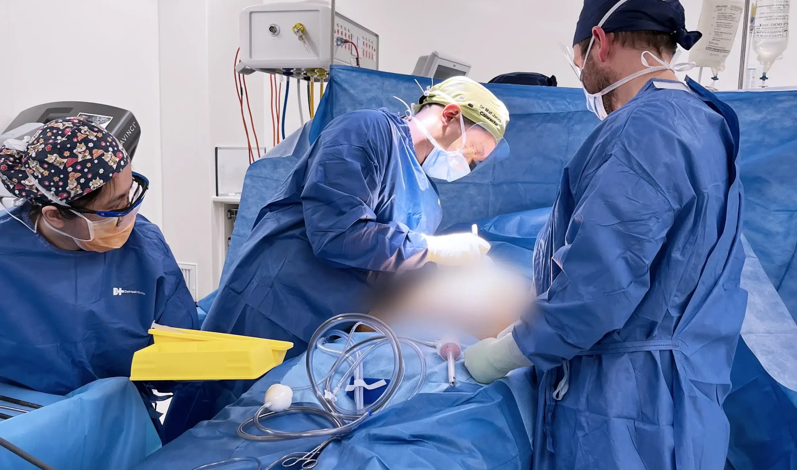 Surgeons performing surgery in operating room.