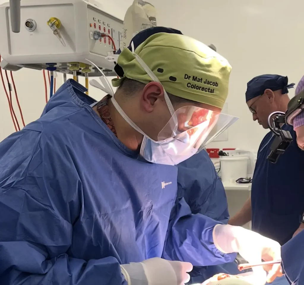 Surgeons performing surgery in operating theatre.