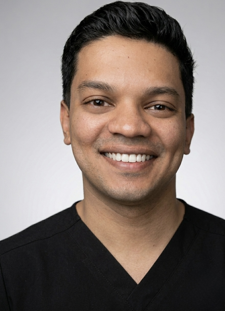 Smiling person in black shirt, professional portrait.